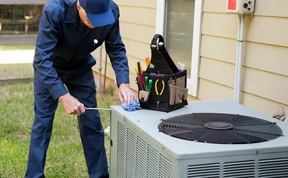 Technician servicing HVAC system, representing reliable and professional HVAC repair solutions.