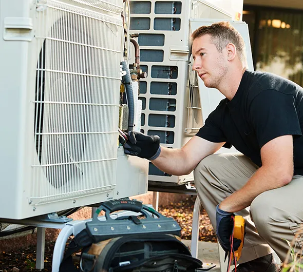 Technician inspecting HVAC system to ensure reliable and efficient heating and cooling service.