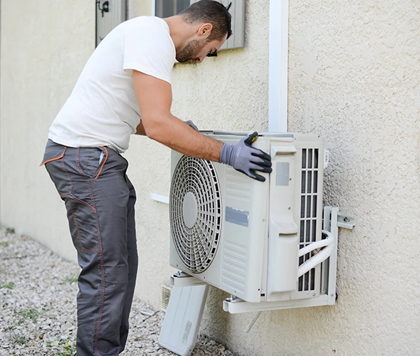 Skilled technician carefully installing HVAC unit for efficient climate control in residential property